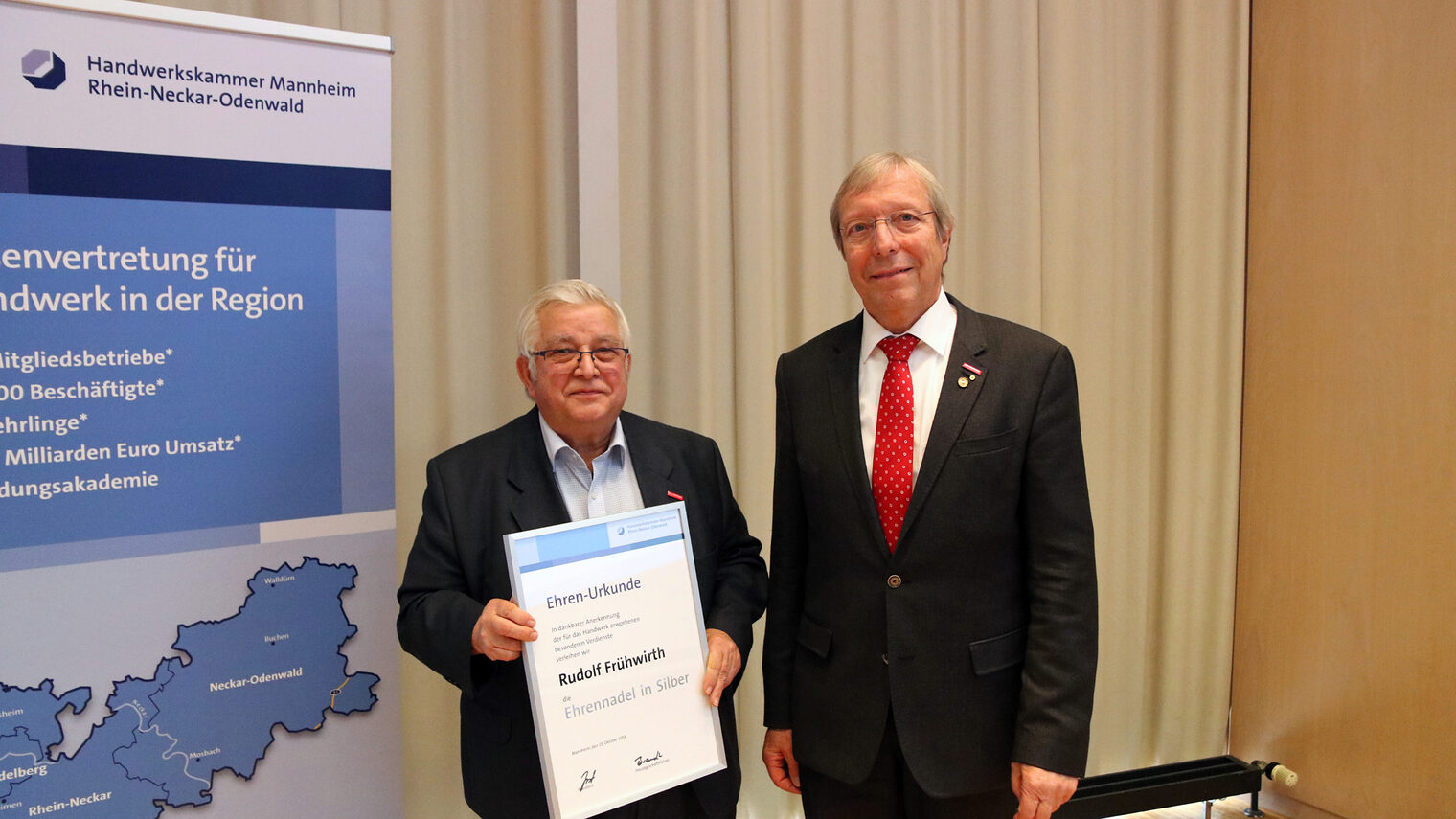 ©Handwerkskammer - Kammerpräsident Alois Jöst (rechts) ehrt Rudolf Frühwirth (links) mit der Silbernen Ehrennadel