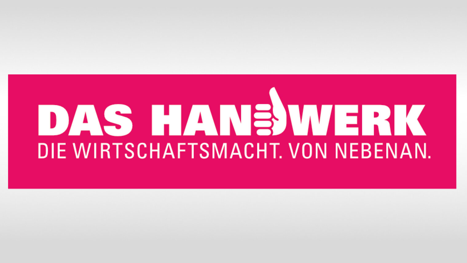 Aufschrift "Das Handwerk - die Wirtschaftsmacht von nebenan" weiße Schrift auf pinkfarbenem Hintergrund