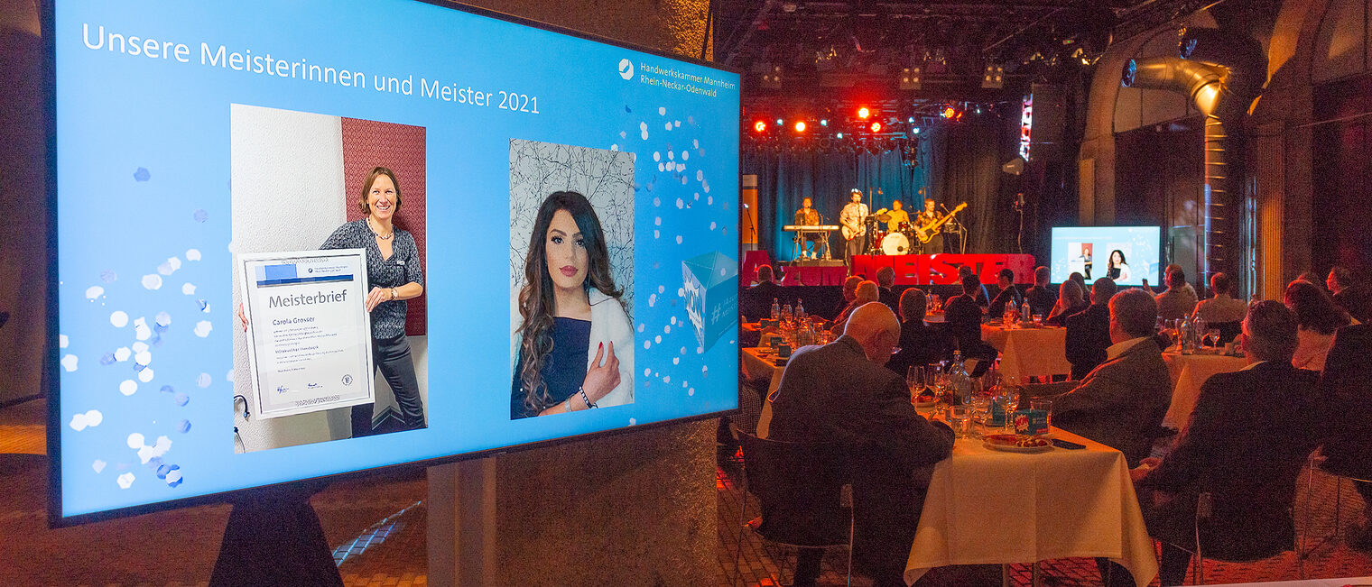 Meisterfeier 2021 - Bildschirm mit Übertragung des Live-Streams und Saalgäste