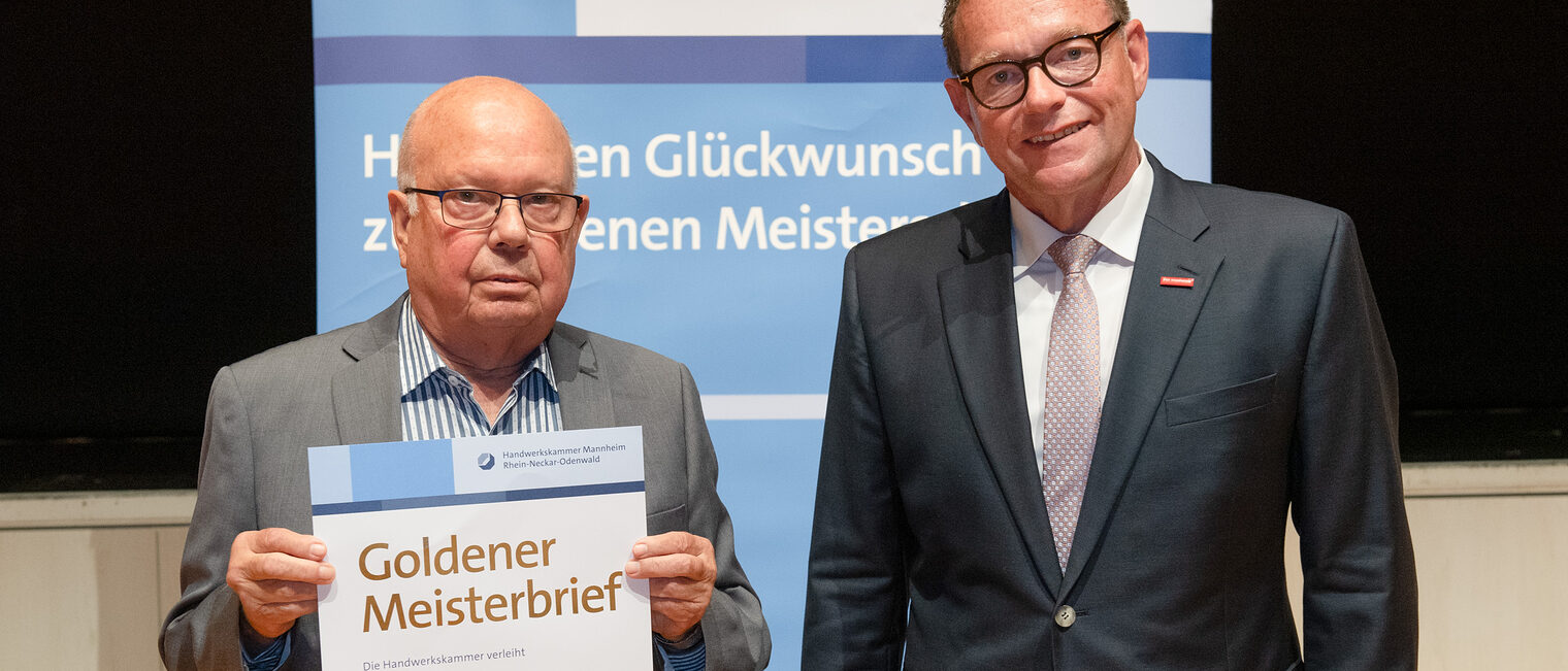 Kammerpr&auml;sident Klaus Hofmann &uuml;berreicht B&auml;ckermeister Hartmut Seiler auf der Goldene Meisterfeier in Wiesloch 2022 seinen Goldenen Meisterbrief